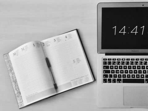 Flat lay photography of unfold organizer book beside macbook. Photo by Michaela: https://www.pexels.com/photo/flat-lay-photography-of-unfold-book-beside-macbook-295826/